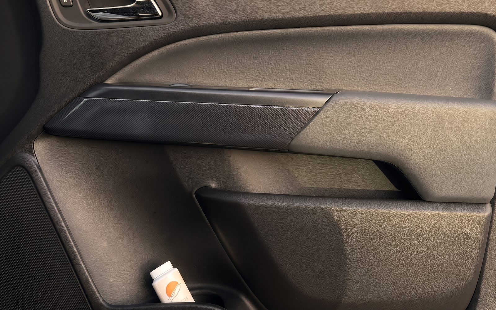 OFFDUNE Reset Powder bottle tucked into the door pocket of a truck, warm evening light through the window