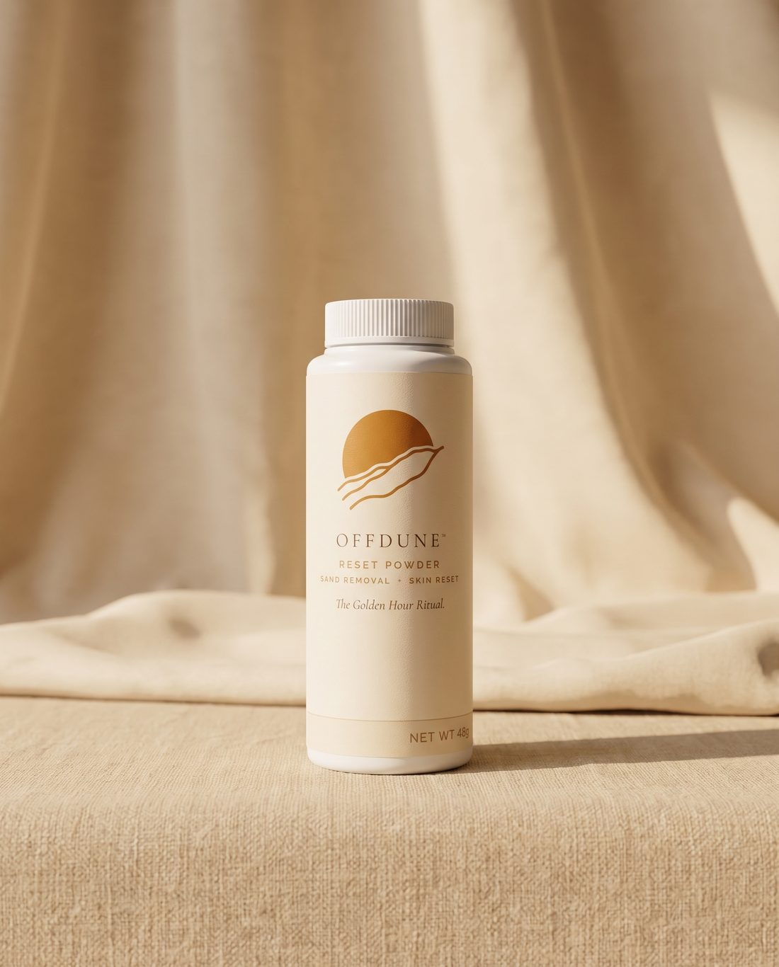 OFFDUNE Reset Powder bottle standing on natural linen in warm afternoon light